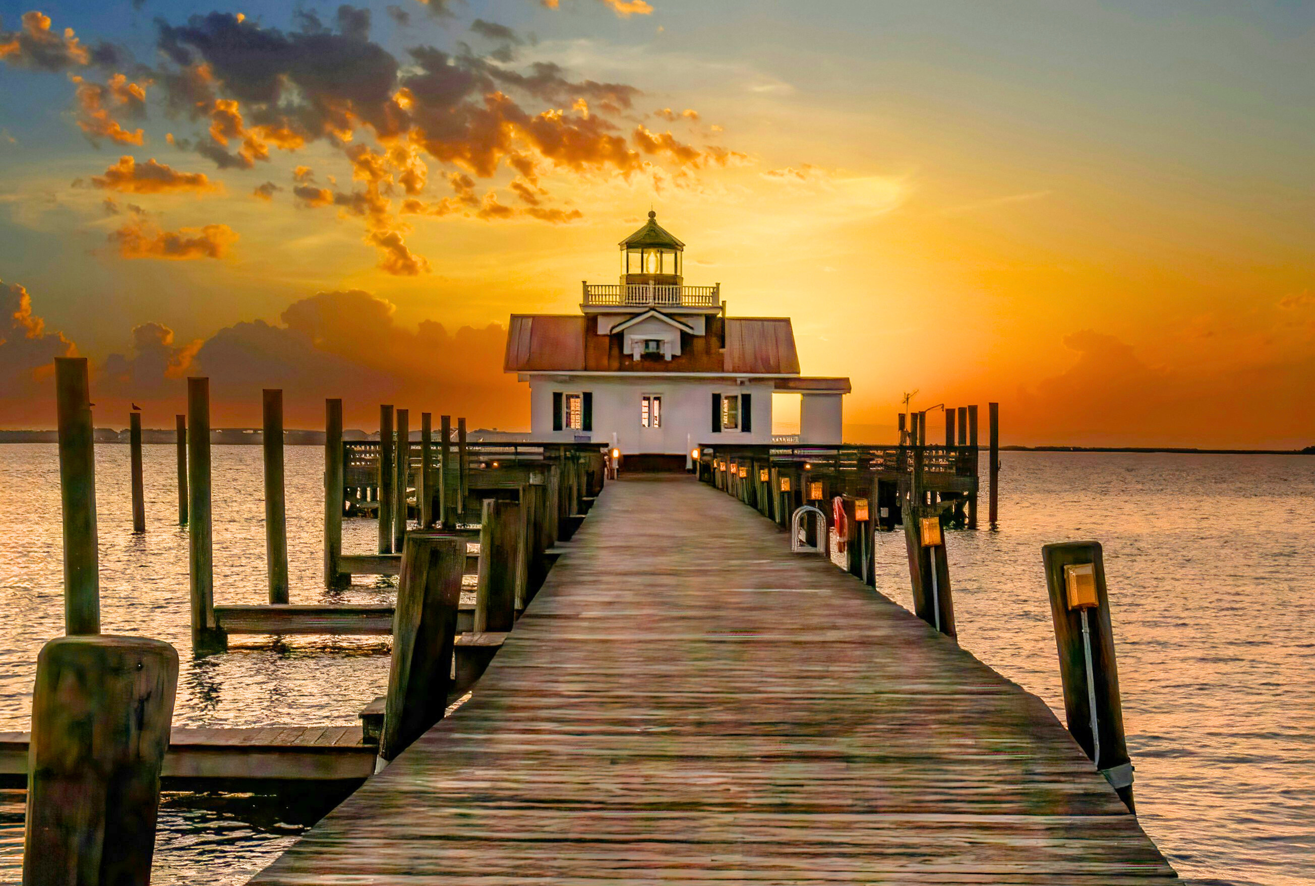 Roanoke Marshes Lighthouse glowing at sunset in Manteo, Outer Banks.